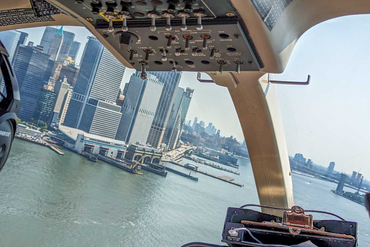 Helicopter flies over the Hudson River in New York City with views of Manhattan