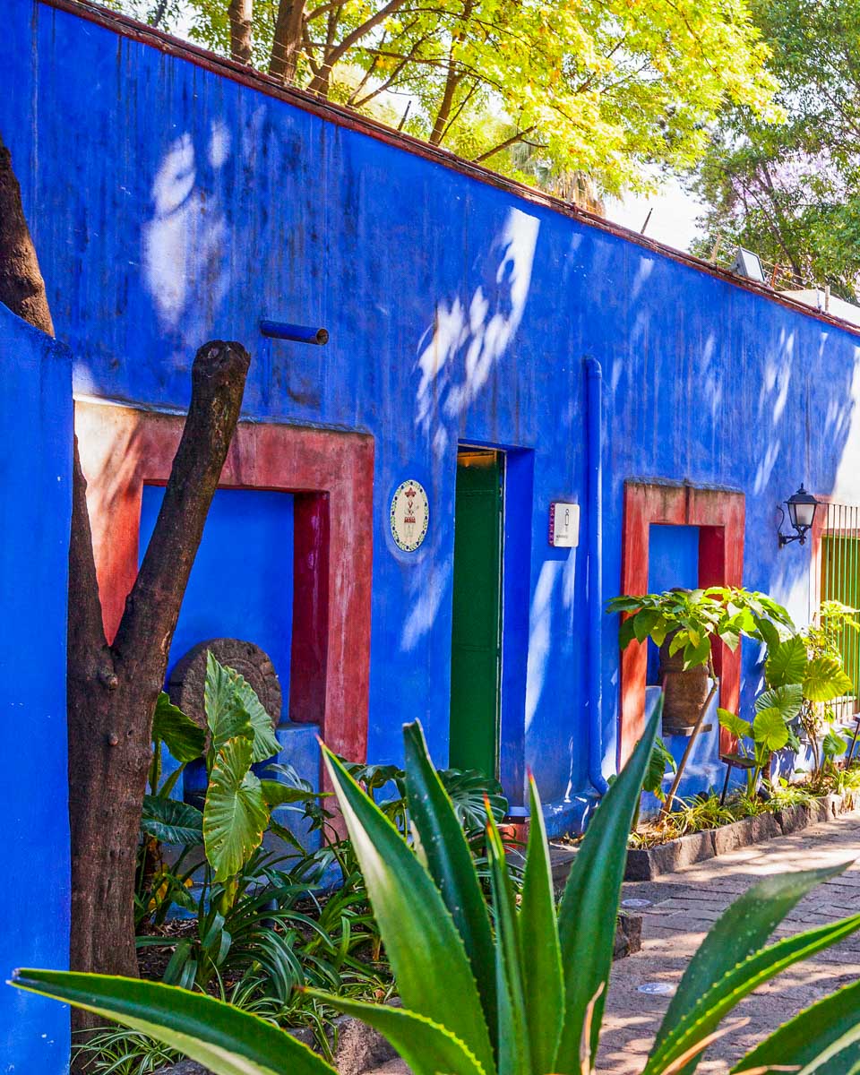 COYOACAN, MEXICO - MARCH 24, 2022: Blue House und courtyard of (La Casa Azul), historic house and art museum dedicated to the life and work of Mexican artist Frida Kahlo