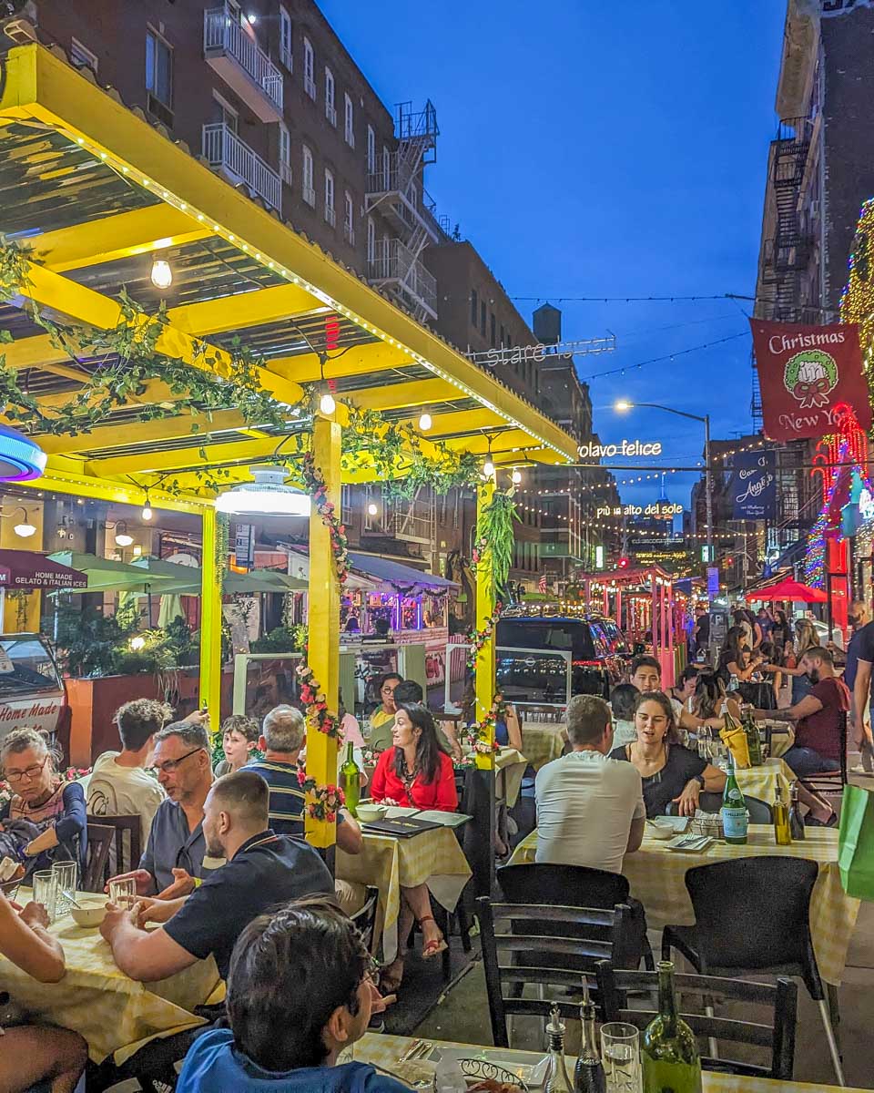 People eat dinner in Little Italy New York City