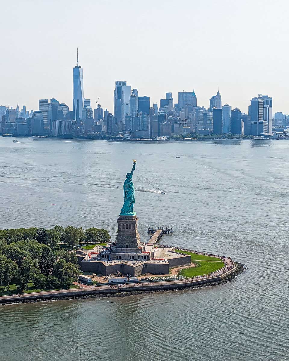 The Statue of Liberty with Manhattan in the background on a helicopter flight in NYC