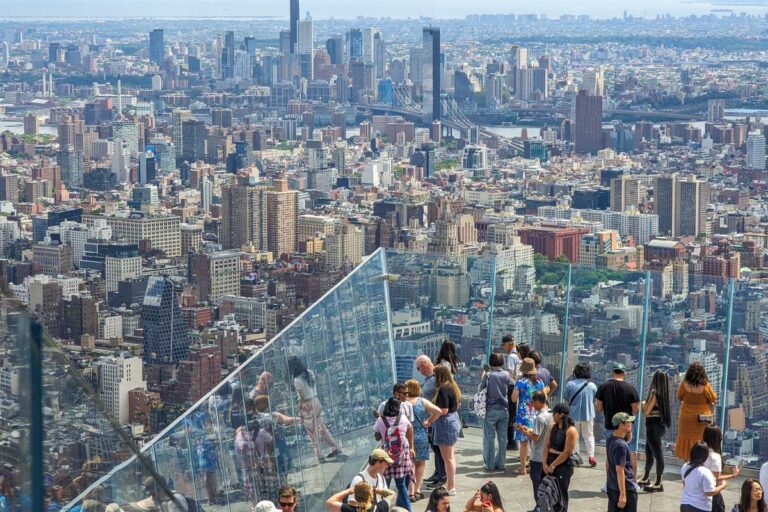 Tourists stand on the balcony at the Edge NYC