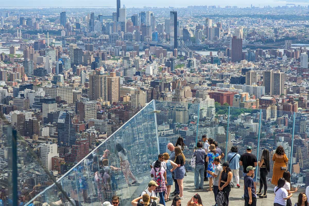 Tourists stand on the balcony at the Edge NYC