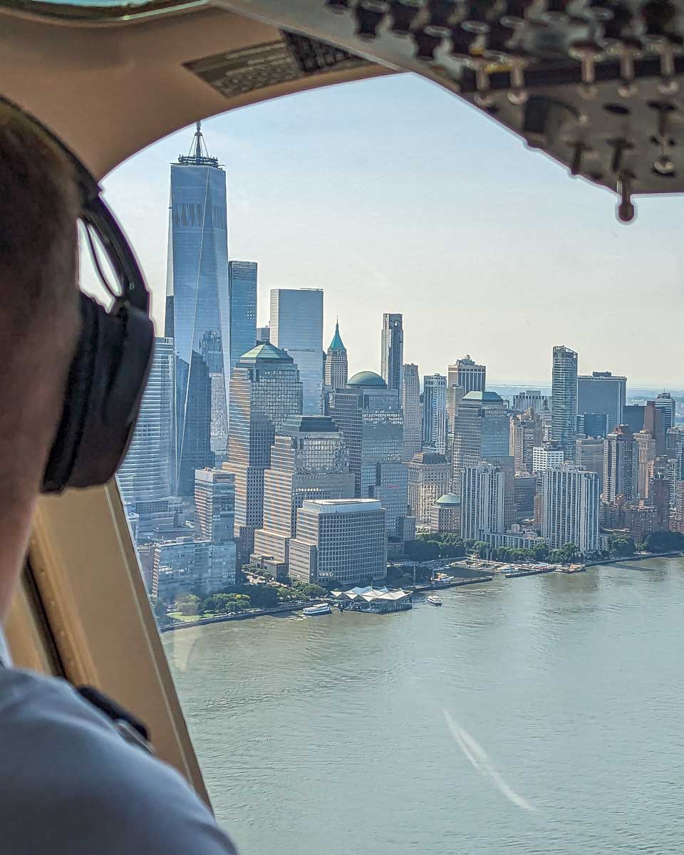 View out the front windo on a helicopter on a helicopter ride in New York City looking down at Manhattan
