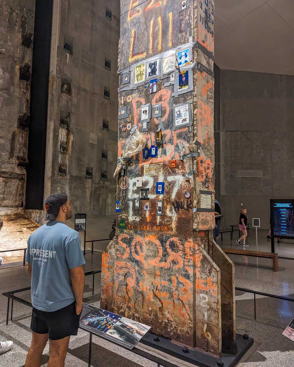 A man inside the 911 museum looks at a steal beam that fell during the World Trade center terrorist attack