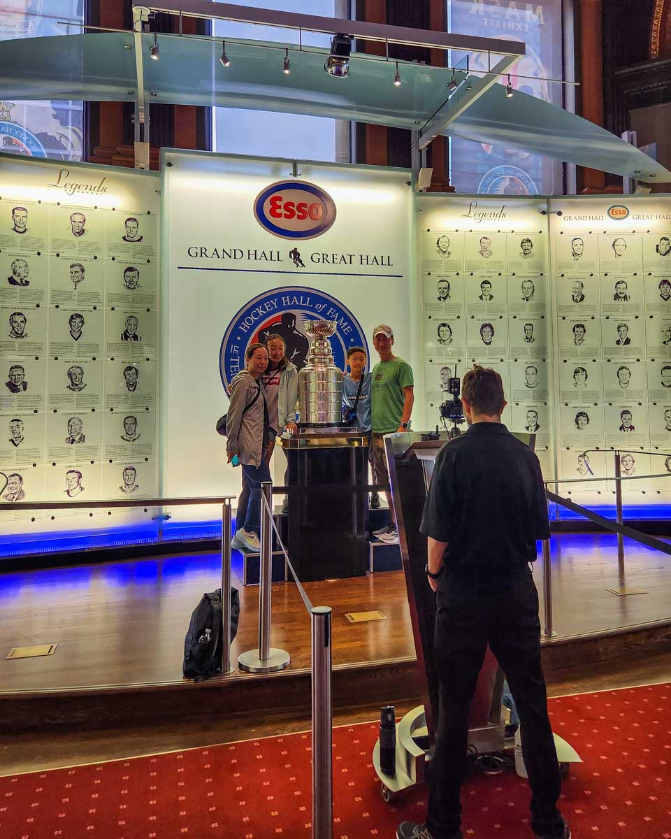 A photographer takes photos of people with the Stanley Cup at the Hockey Hall of Fame in Toronto