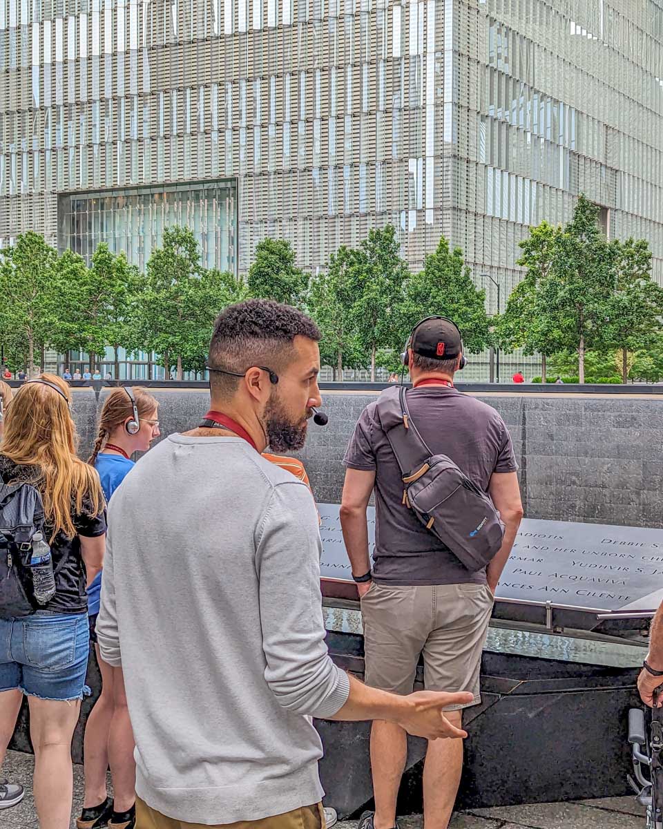 A tour guide at the 911 Memorial explains about the attack on a tour in New York City