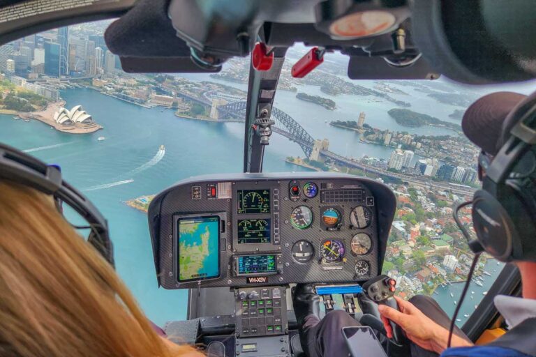 Bailey and the pilot fly over the Sydney Opera House on a tour booked on Viator