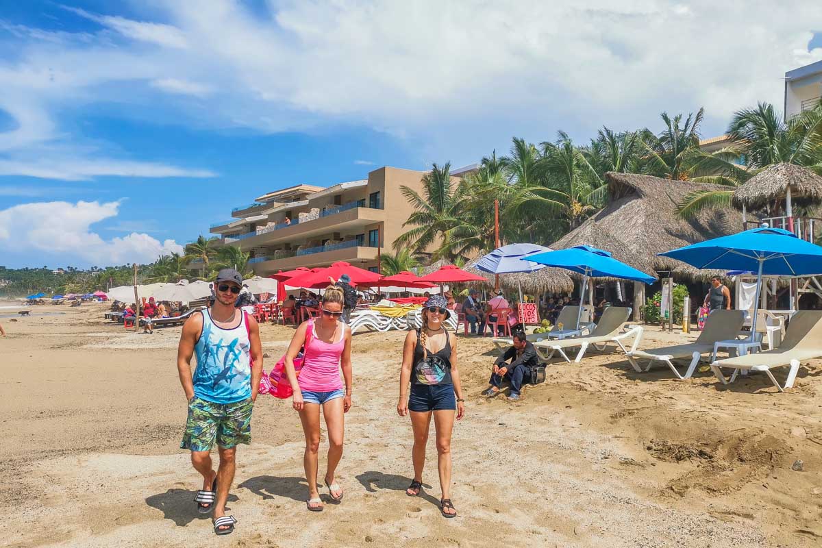 Bailey and two of her friends walk along a the beach in Sayulita Mexico