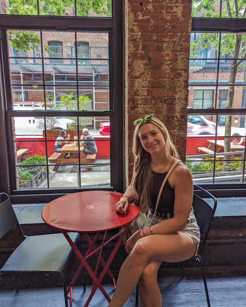 Bailey sits on a chair inside the Chelsea Market in New York City