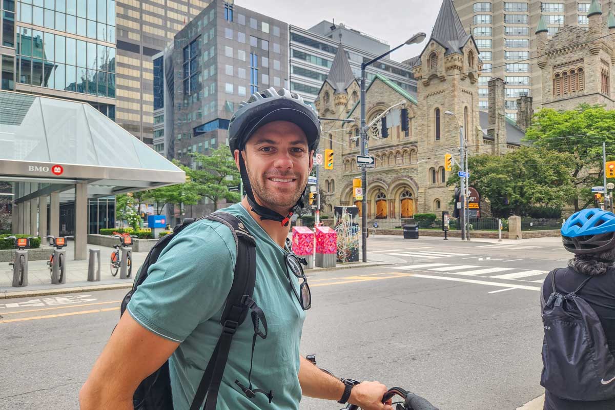 Daniel smiles at the camera on a tour through downtown Toronto
