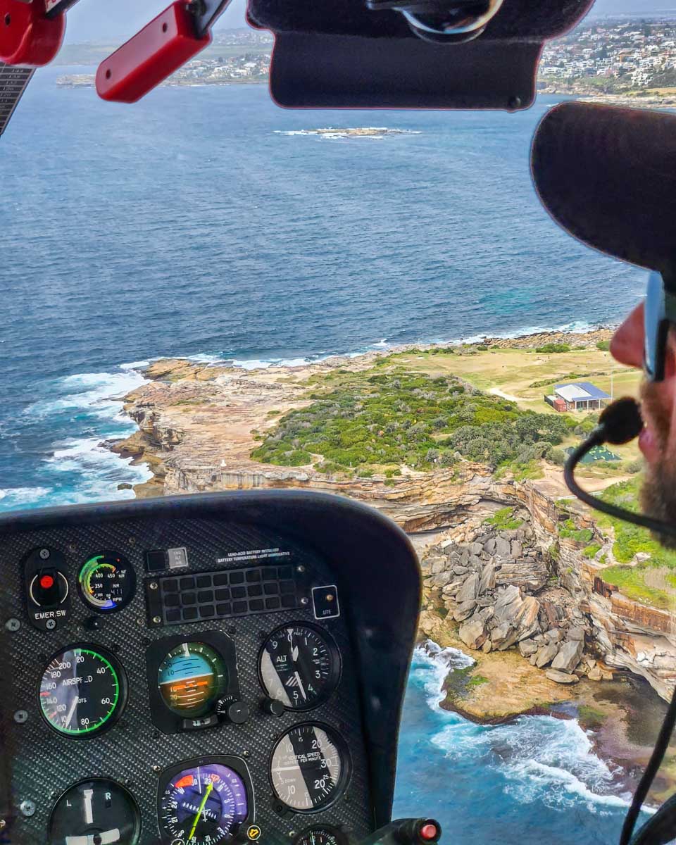 The cliffs of Sydney as seen through the Pilots window on a helicopter flight