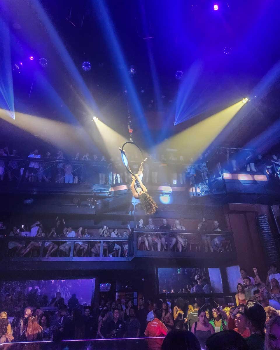 A dancer hangs from a ring at Coco bongo in Mexico