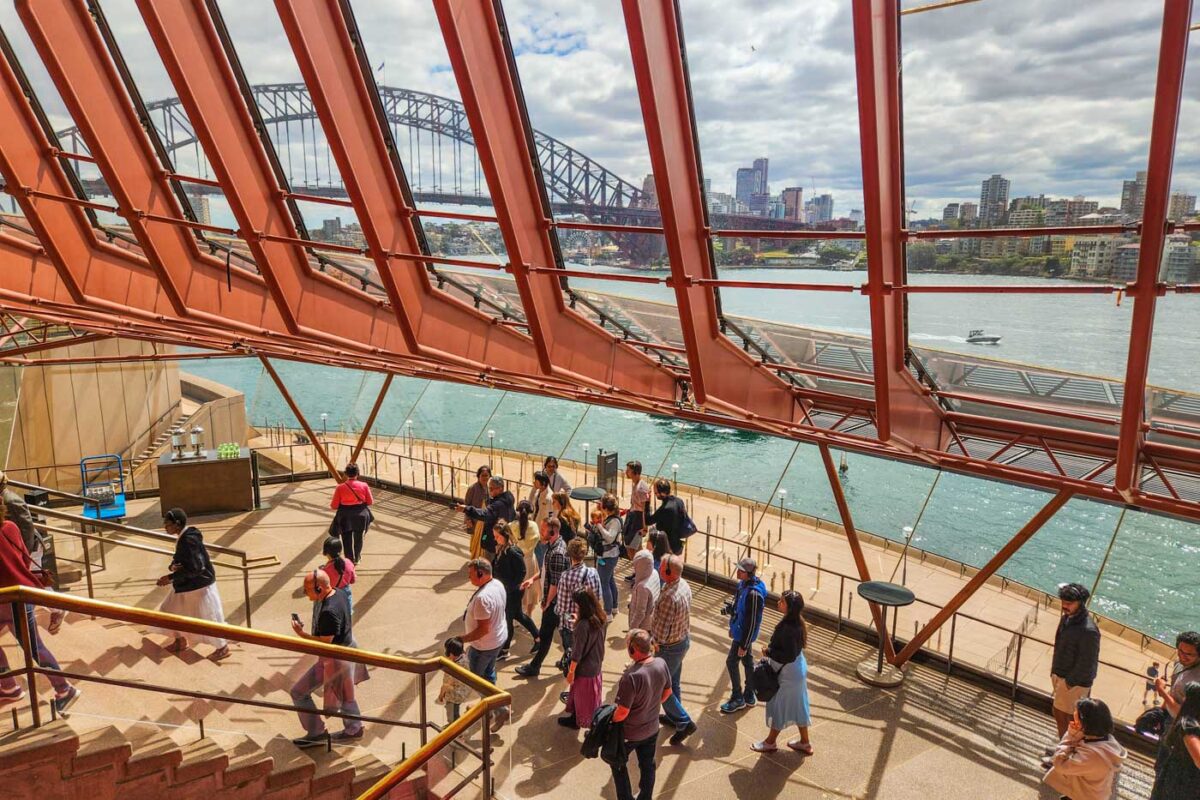A tour group walk the inside of the Sydney Opera House