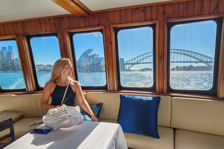 Bailey looks out the window from the dinning hall on a Sydney Harbour cruise at the Sydney Harbour bridge and Opera House