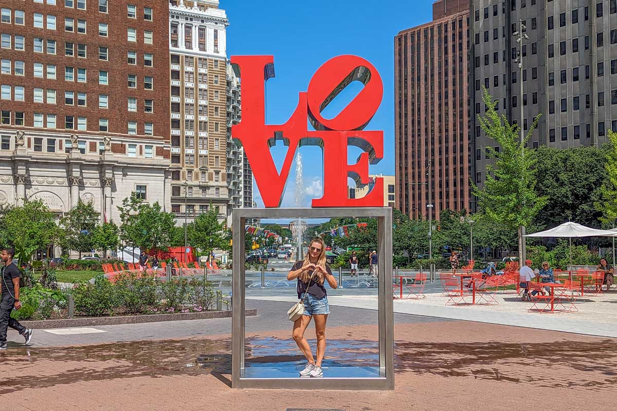 Bailey poses for a photo with the Love Park sign at Love Park in Philadelphia