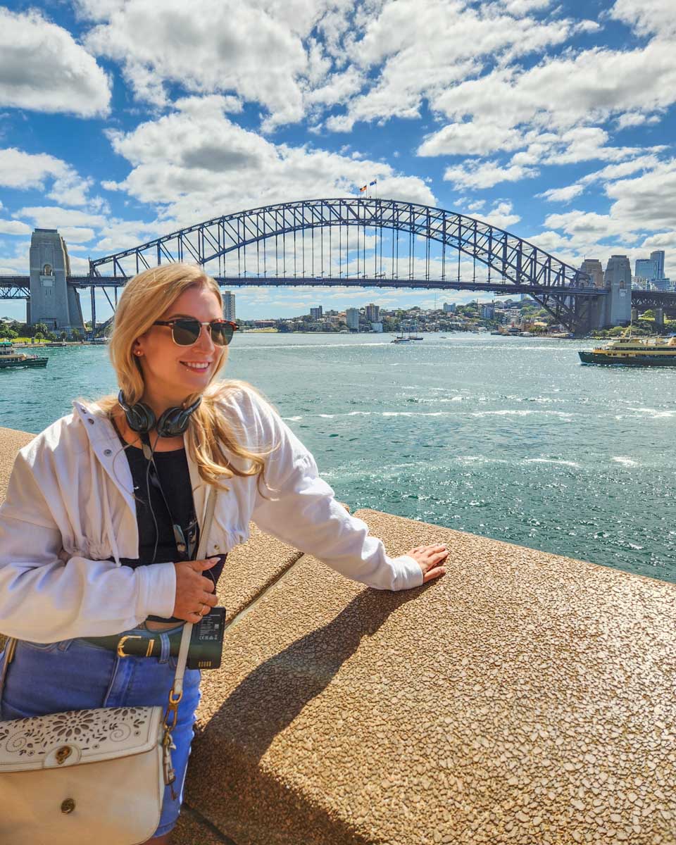 Bailey poses for a photo with the Sydney Harbour Bridge while on a walking tour of the city