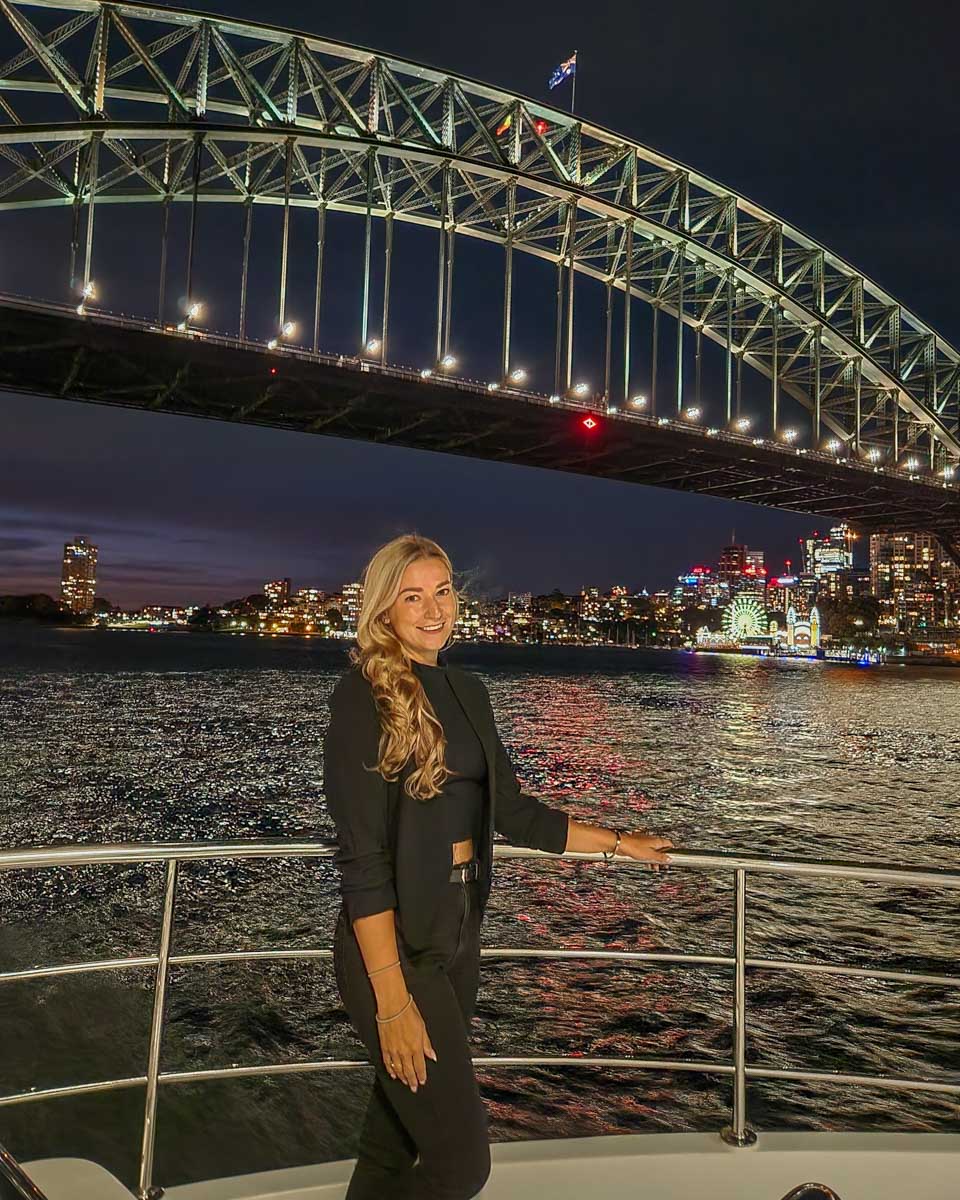Bailey poses for a photo with the Sydney harbour Bridge during the Journey Beyond the Cruise Sydney