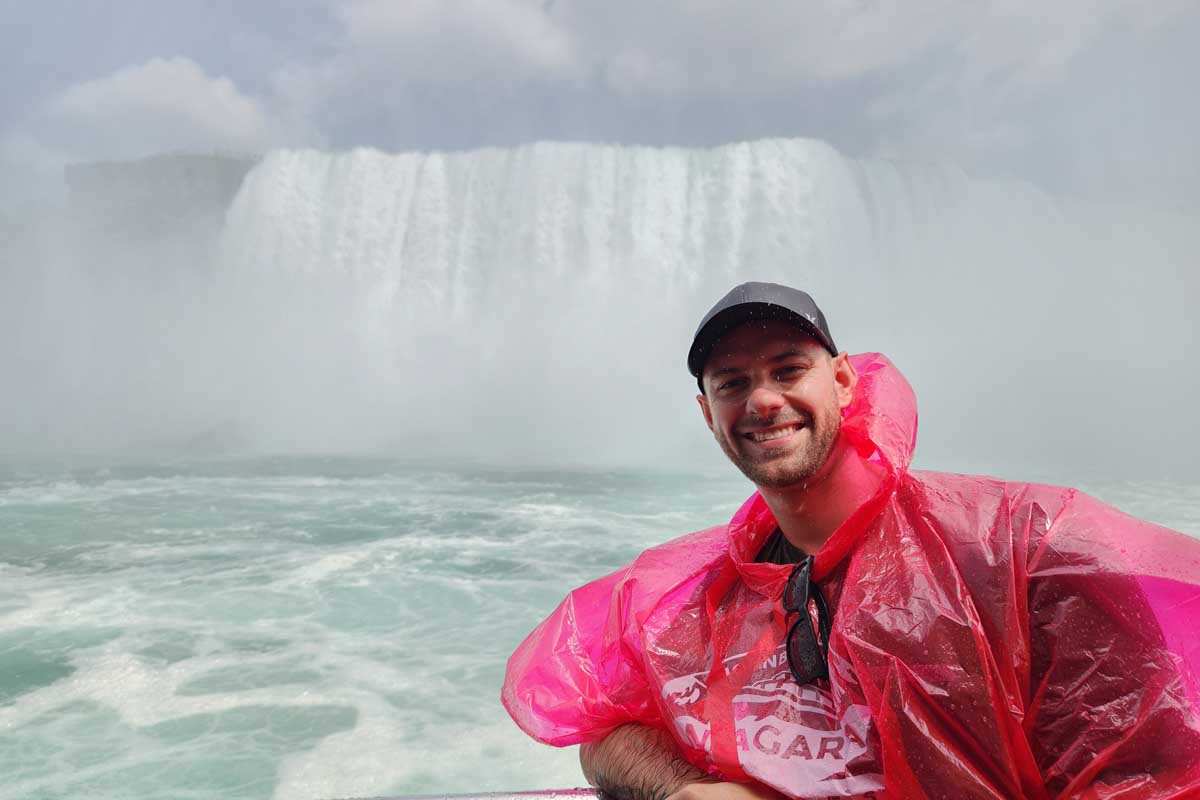 Daniel poses for a photo on a Niagara Falls boat cruise on a trip from New York City