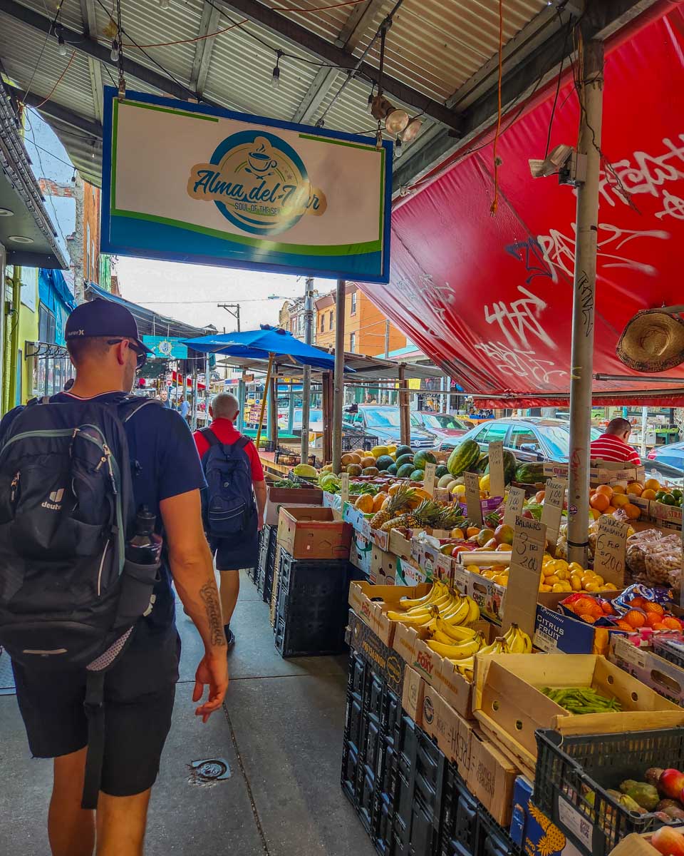 Daniel walks the fruit market in the Italian Market in Philadelphia