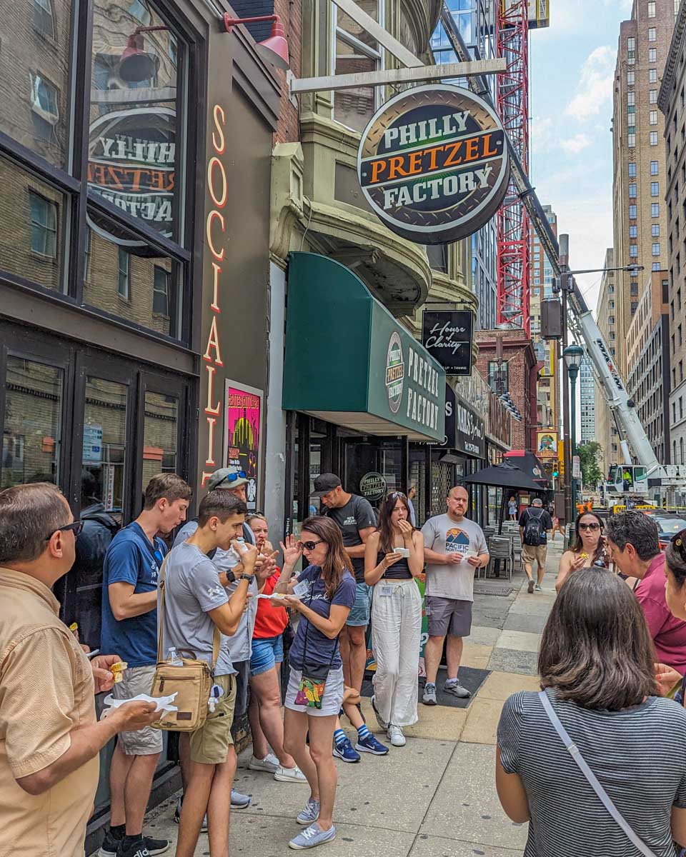 Our food tour group on the streets eating pretzels during our tour in Philadelphia
