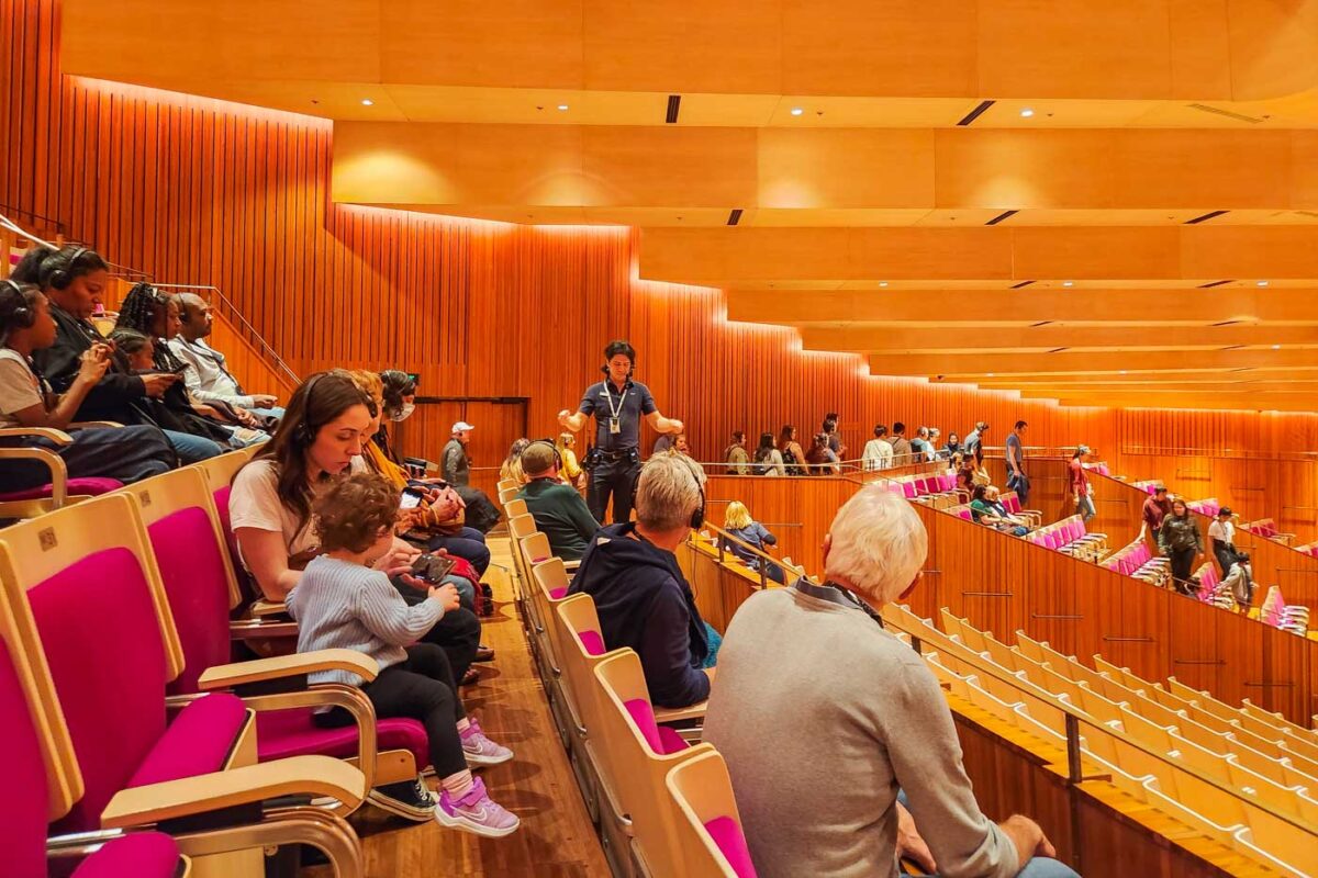 Our guide talks about the concert hall while we sit in the seats and listen
