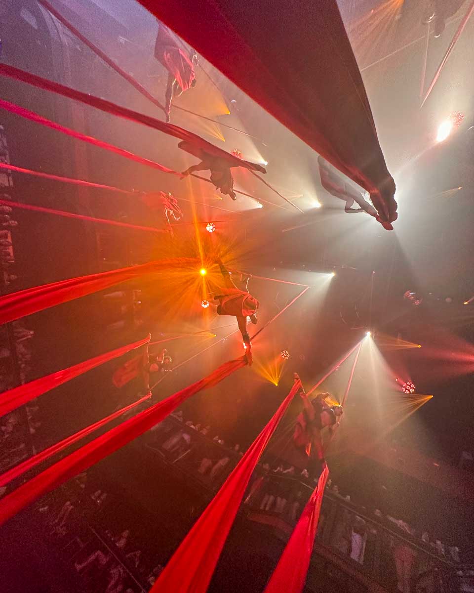 Silk dancers hang from the roof of Coco bongo during a performance