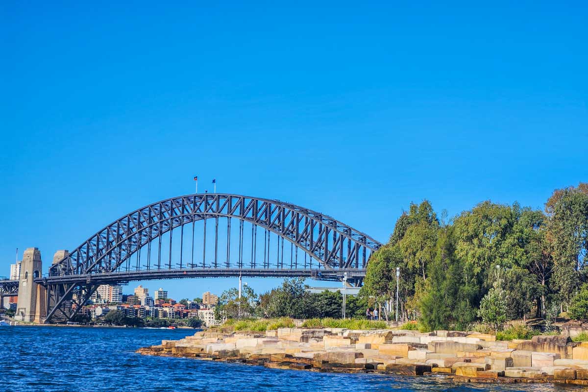 The Sydney Harbour Bridge sits in the distance as seen from the water