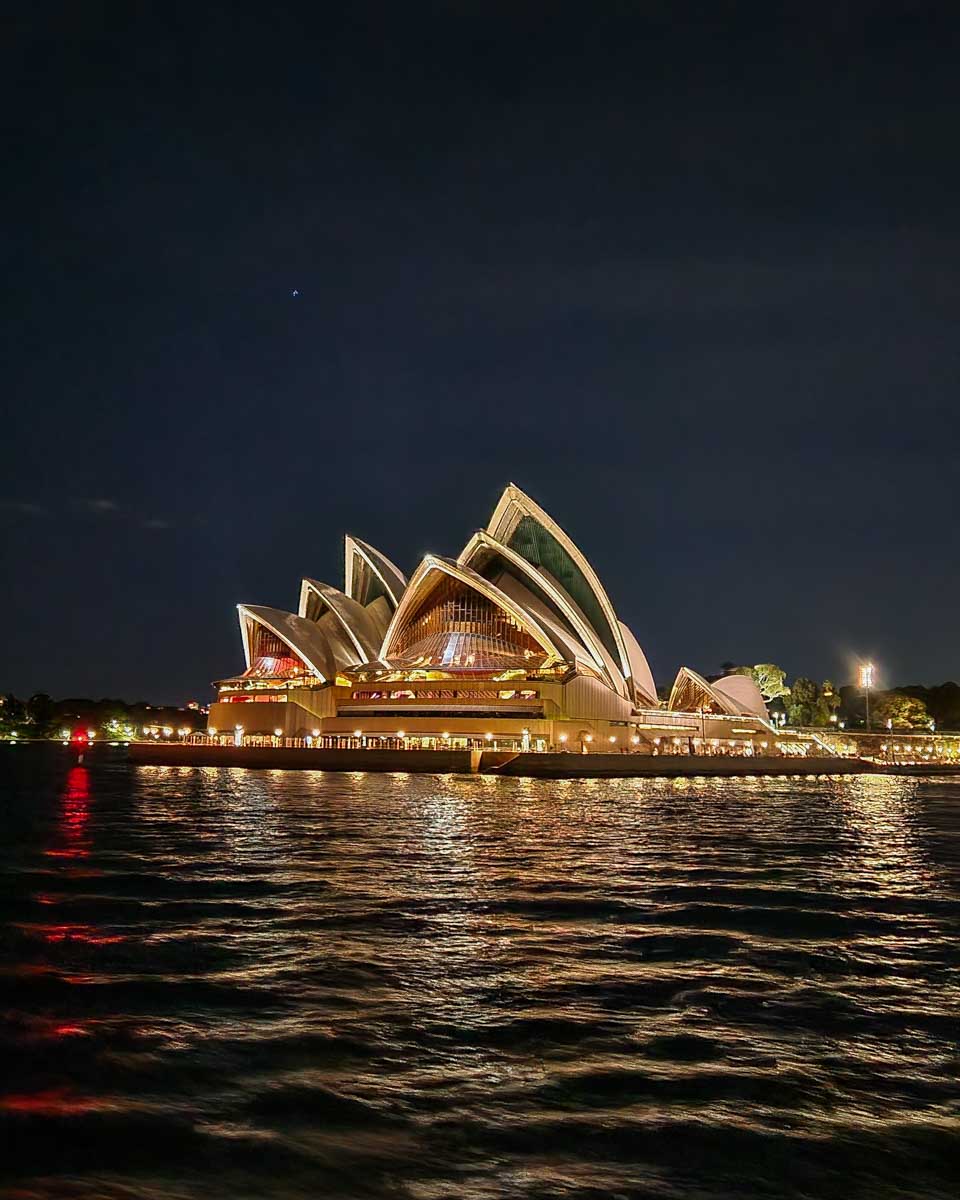 The Sydney Opera House lit up at night as seen from the dinner cruise in Sydney Harbour