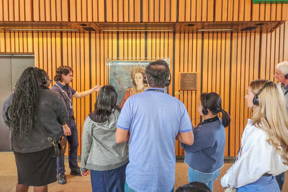 Tour guide explains a painting inside the Sydney Opera House, Australia