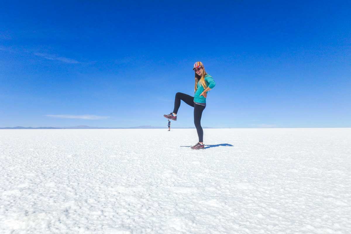 Bailey uses the Uyuni Salt Flat to take a funny photo that looks like she is stepping on Daniel