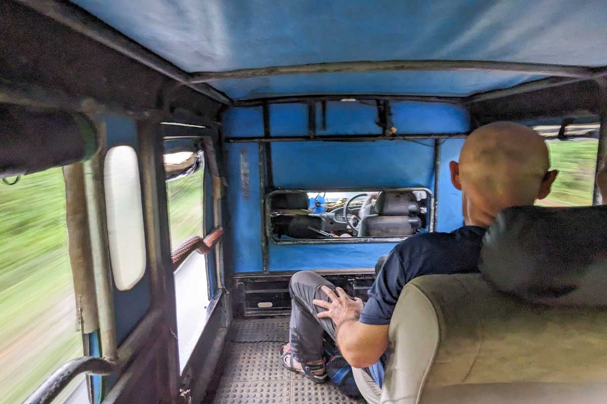Our guide driving our jeep quickly down a road to find animals in Minneriya National Park Sri Lanka