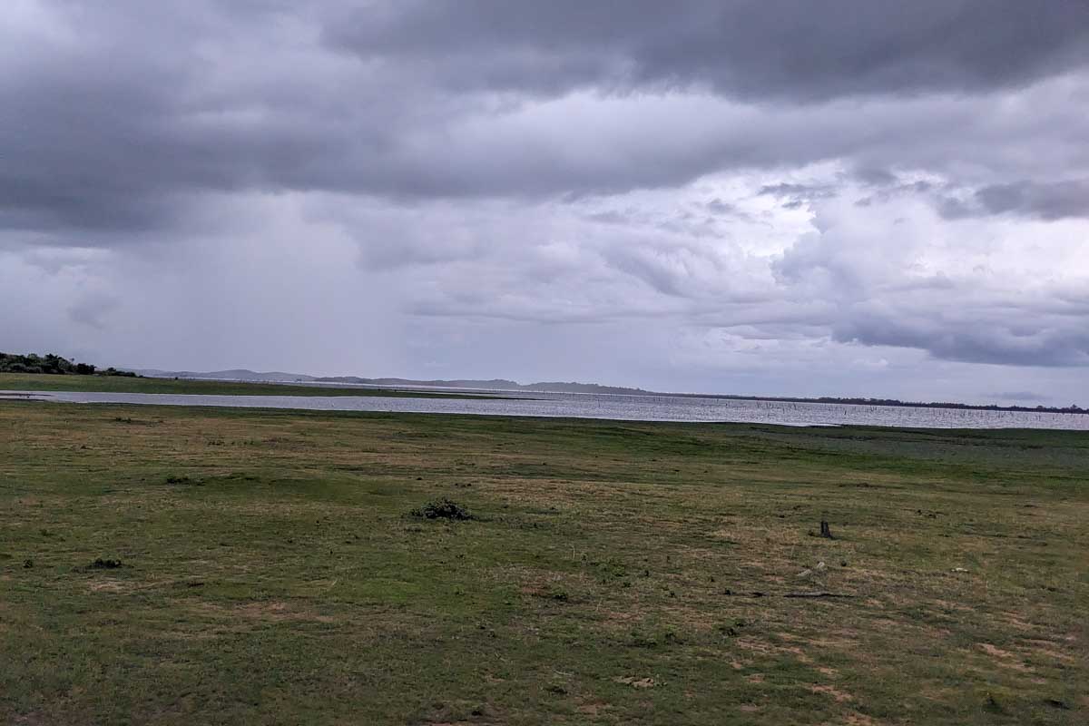 Watching a rain storm come over Minneriya reservoir Sri Lanka