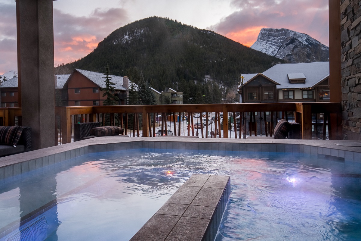 a hot pool with a mountain view at Meadow Spa and Pools