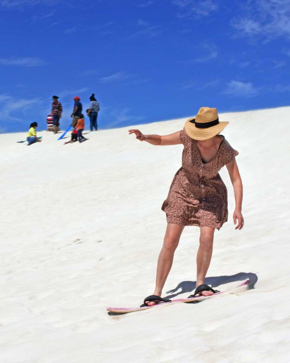 A lady snowboards in Lancelin, Australia