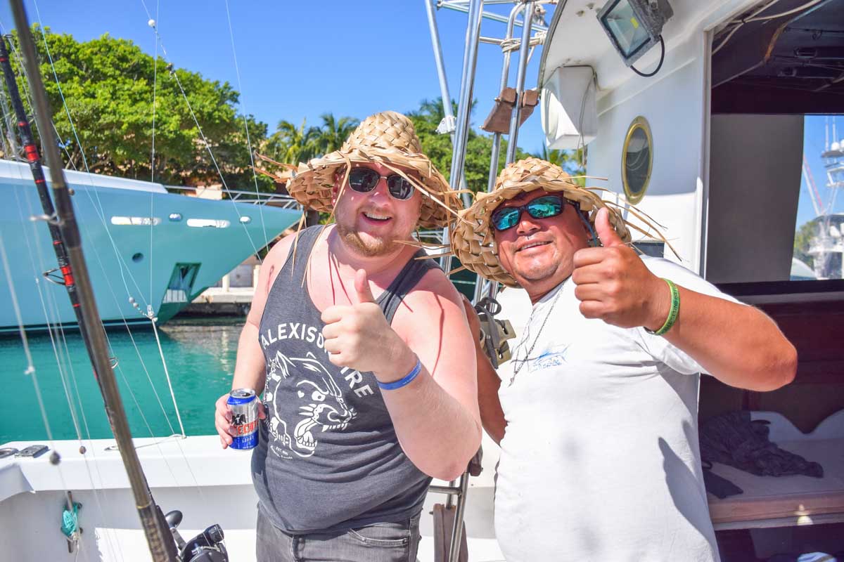 A person from our tour poses for a photo with the captain of the boat in Puerto Vallarta, Mexico