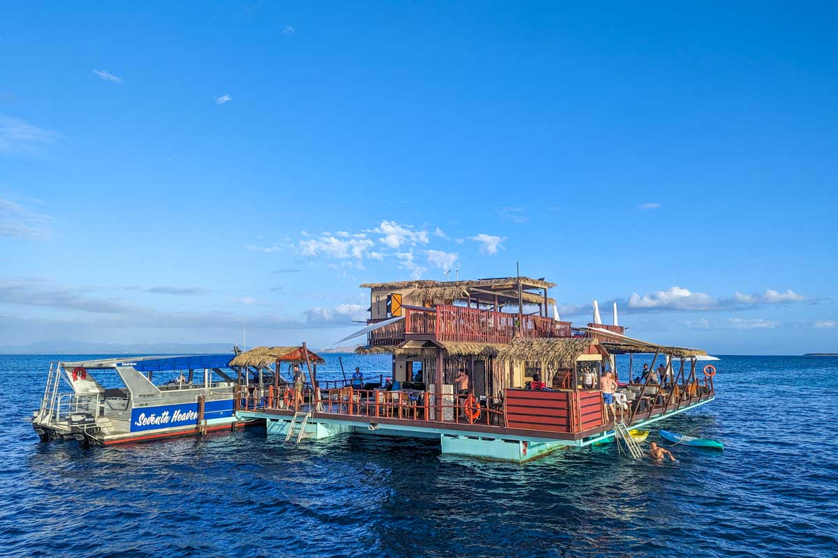 A boat drops people at Seventh Heaven Fiji Floating Platform