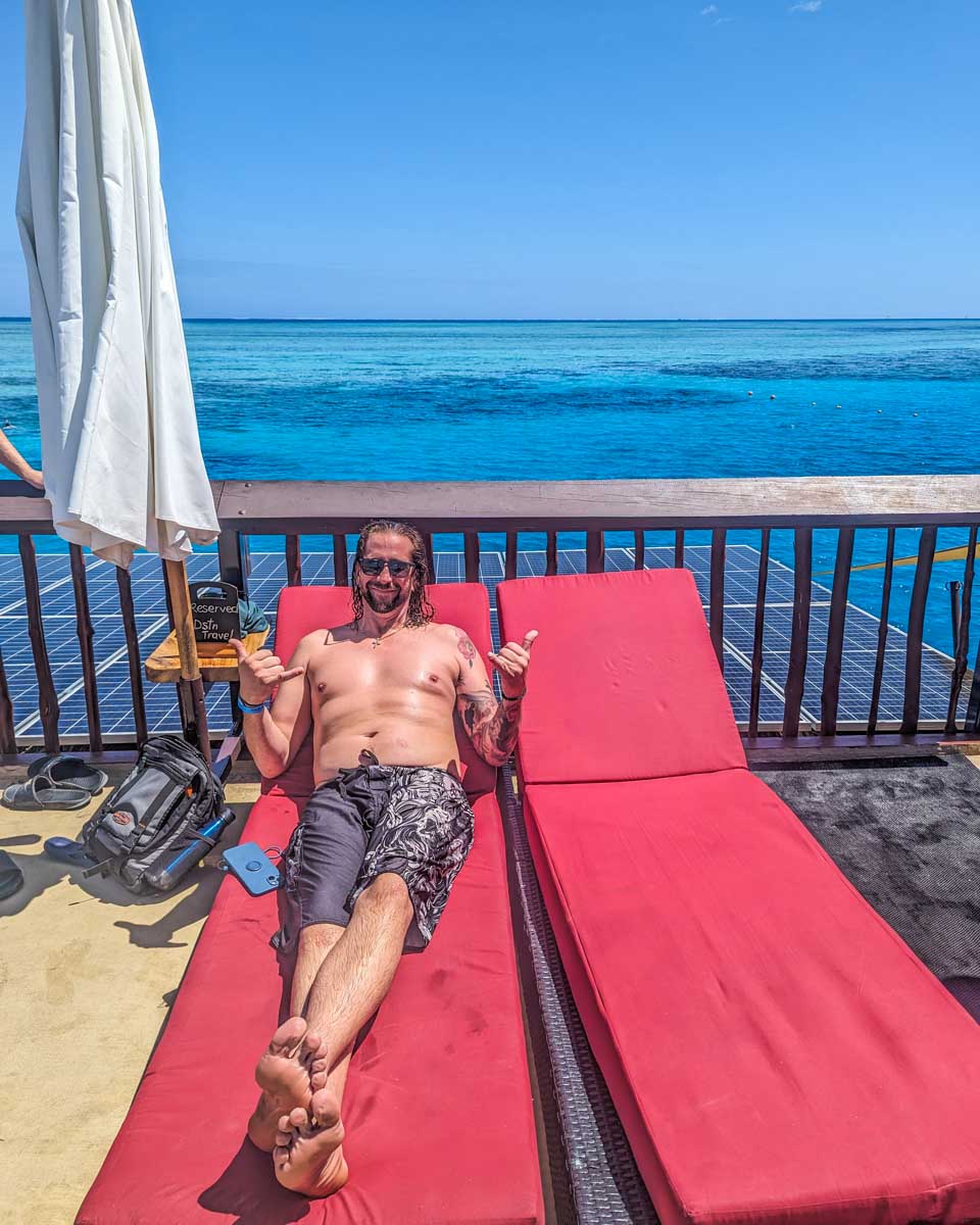 A friend sof Daniels relaxes on a day bed on Seventh Heaven Fiji floating platform
