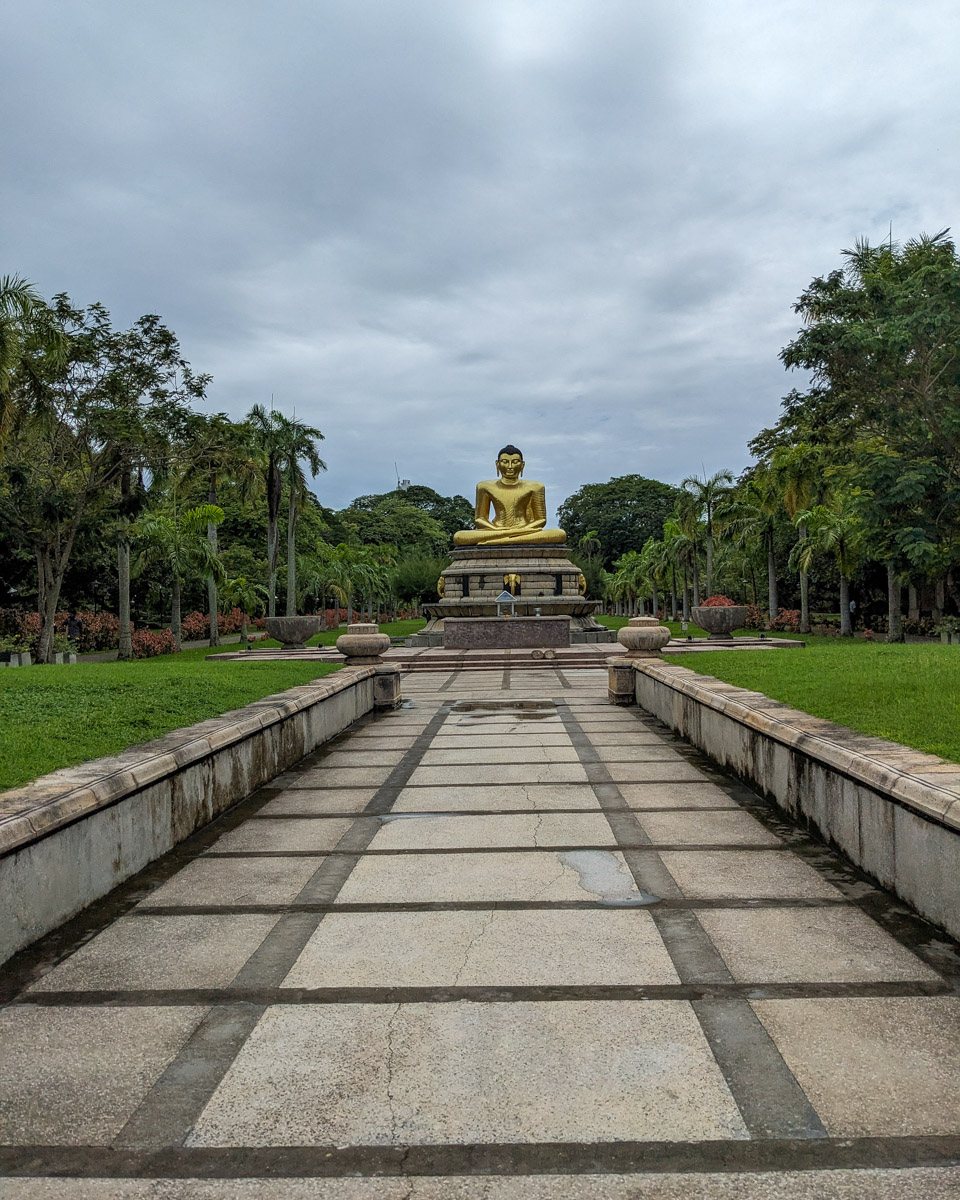 A meditating golden Buddha statue in Viharamahadevi Park across from Colombo Town Hall Colombo, Sri Lanka