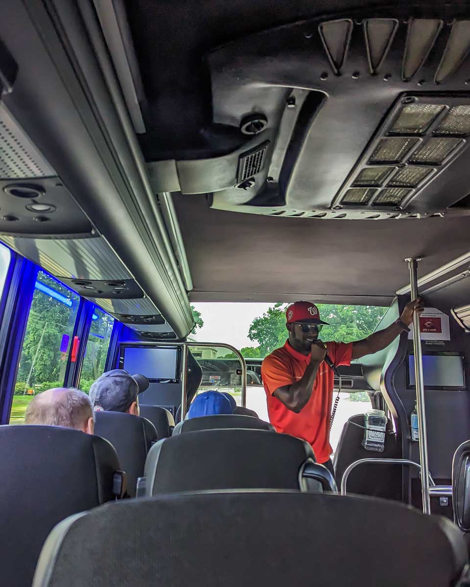 A tour guide talks to our group on a bus during a sightseeing tour in Washington DC