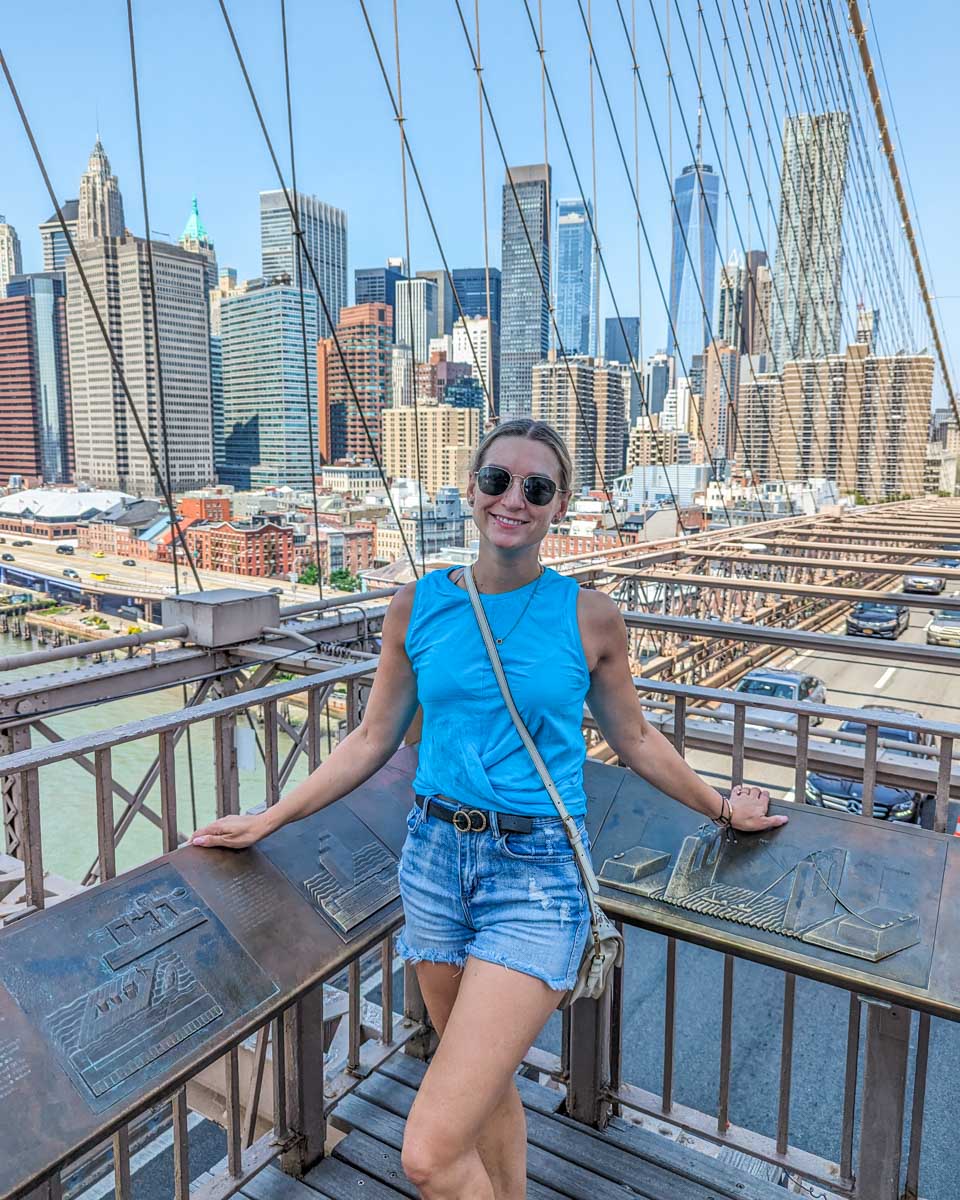 Bailey poses for a photo on the Brooklyn Bridge in New York City while walking over it