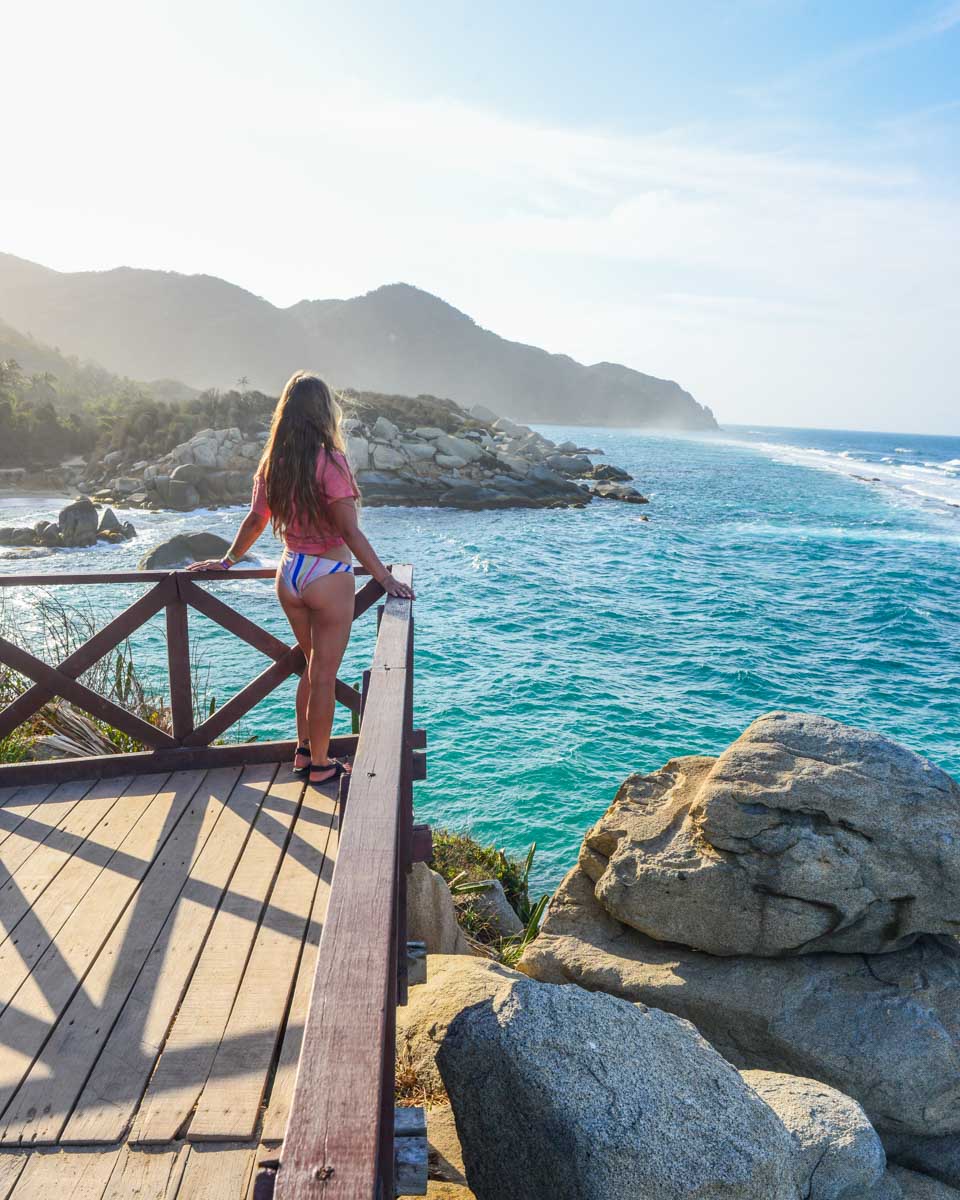 Bailey stands at the wooden viewpoint where people can sleep at Cabo San Juan in Tayrona National Park