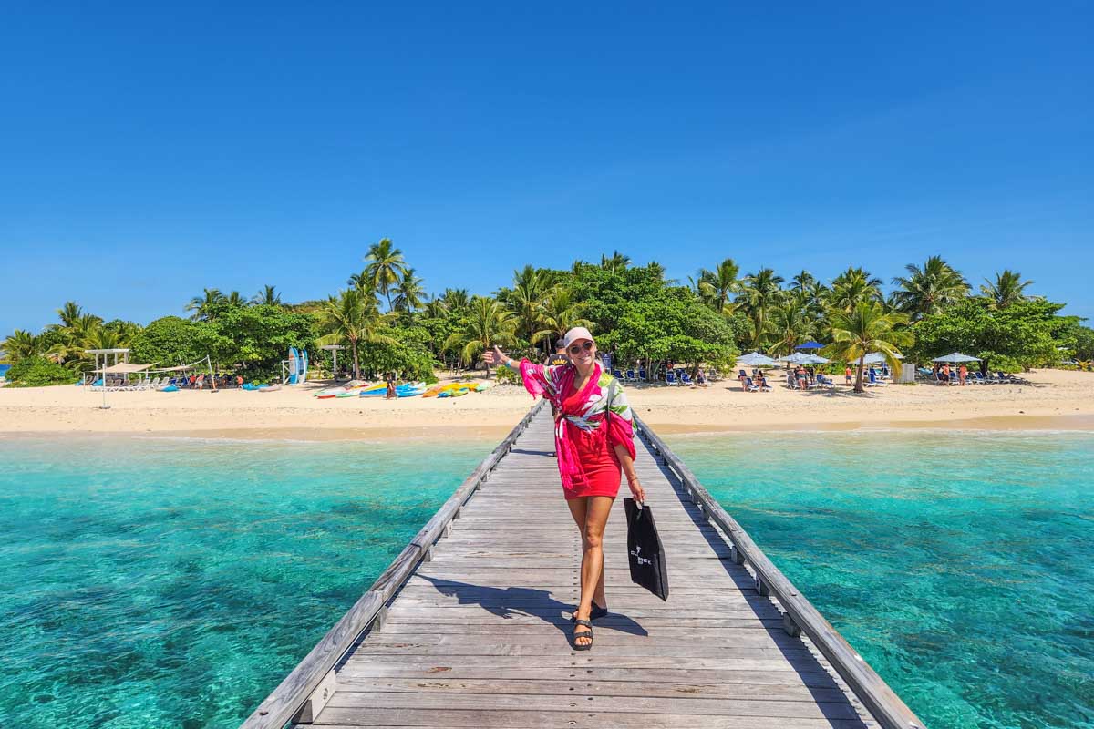 Bailey walks along the jetty to Malamala Beach Club from the boat
