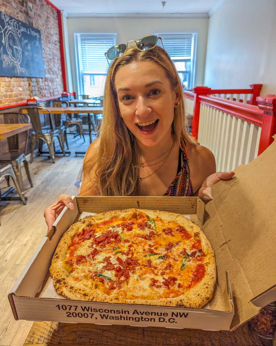 Bailey with a pizza in Georgetown Washington DC on a food tour
