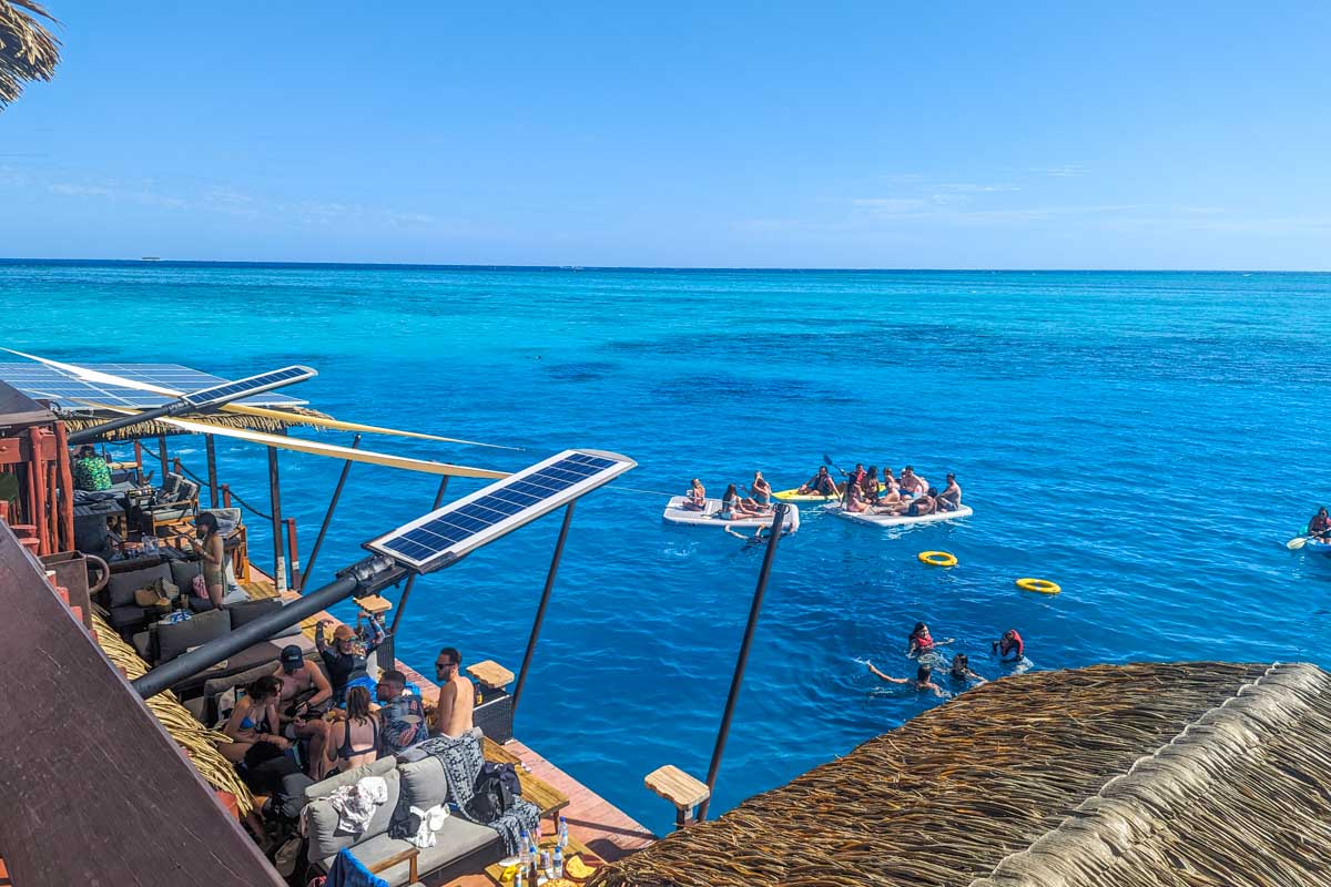 People swim off the Seventh Heaven Fiji floating platform
