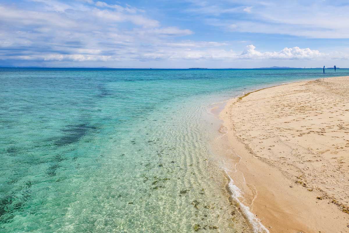 The shallow crystal clear waters of Tivua Island in Fiji