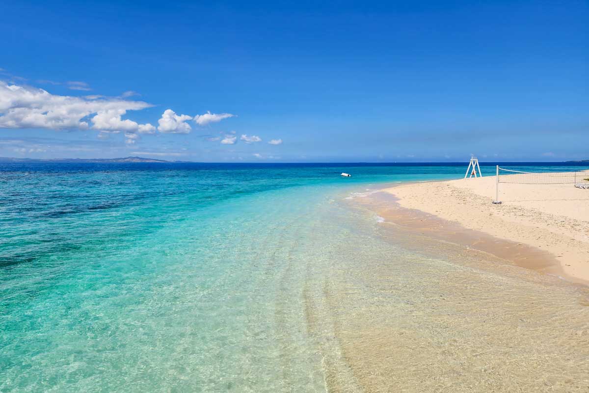White sand beach and blue water at Malamala Beach Club in Fiji