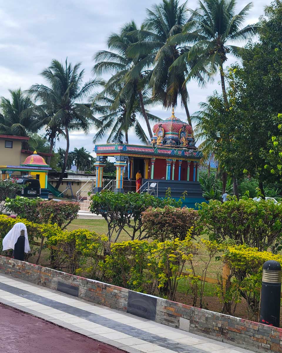 A man praying at a shrine outside at Hindu temple Sri Subramaniya Fiji