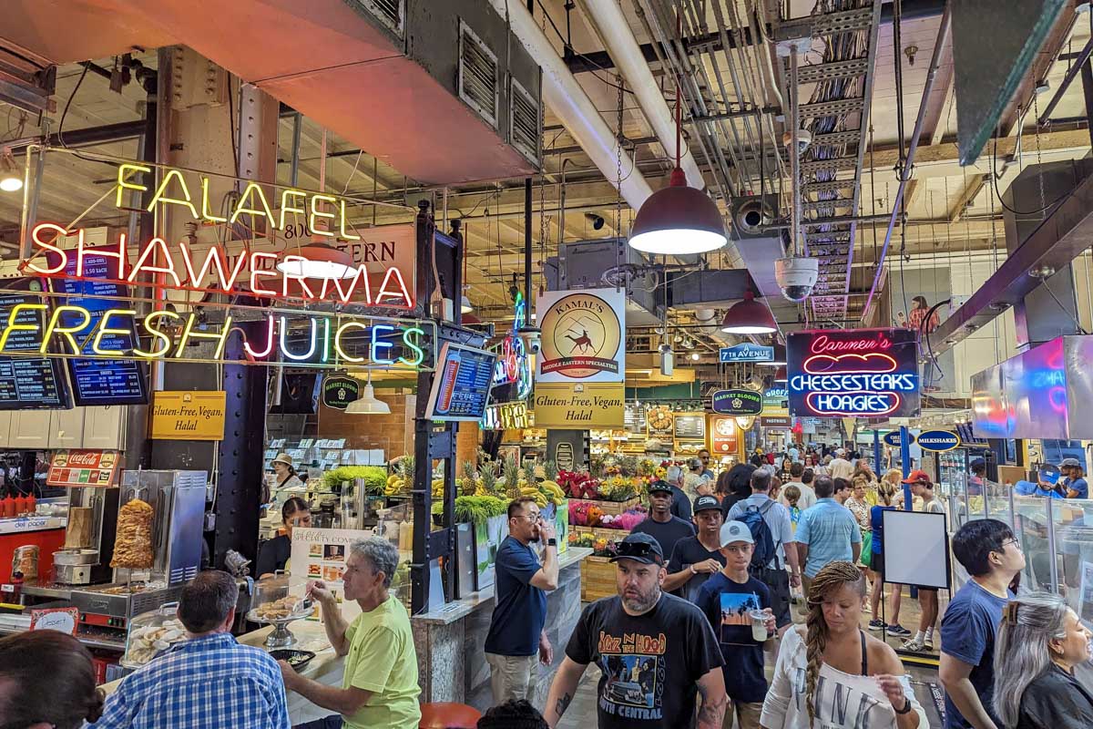 A sign says falafel and there is a crowd at Reading Terminal Market Philadelphia