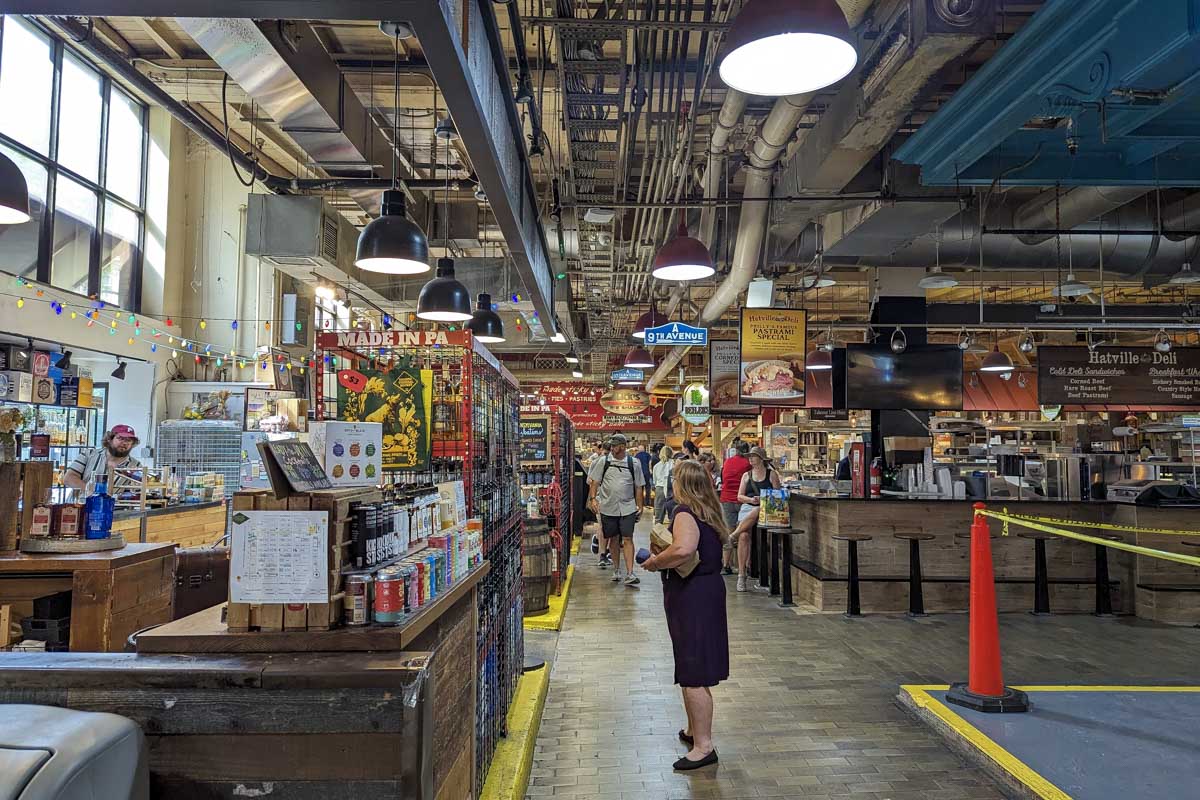 A woman reading a sign at Reading Terminal Market Philadelphia