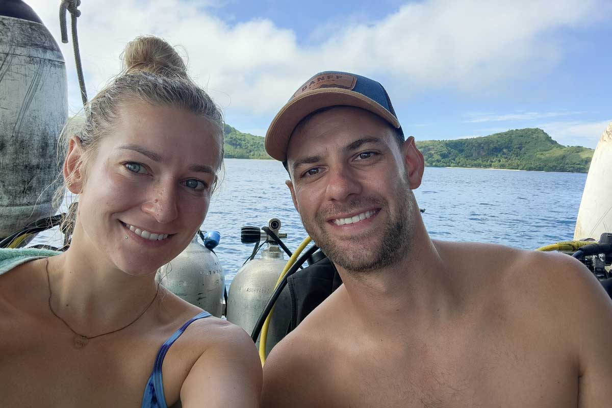 Bailey and Daniel smile on a boat during a shark dive fiji
